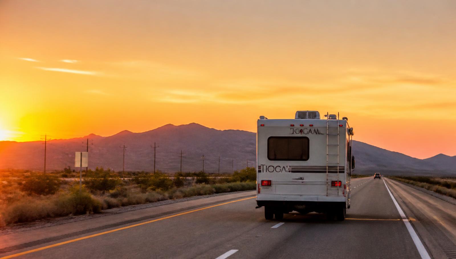 Motorhome traveling a Southern California highway at sunset